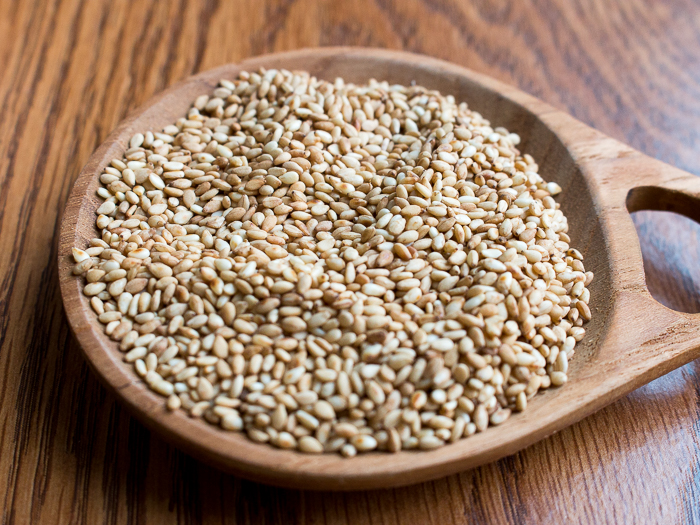 Toasted white sesame seeds in wooden bowl