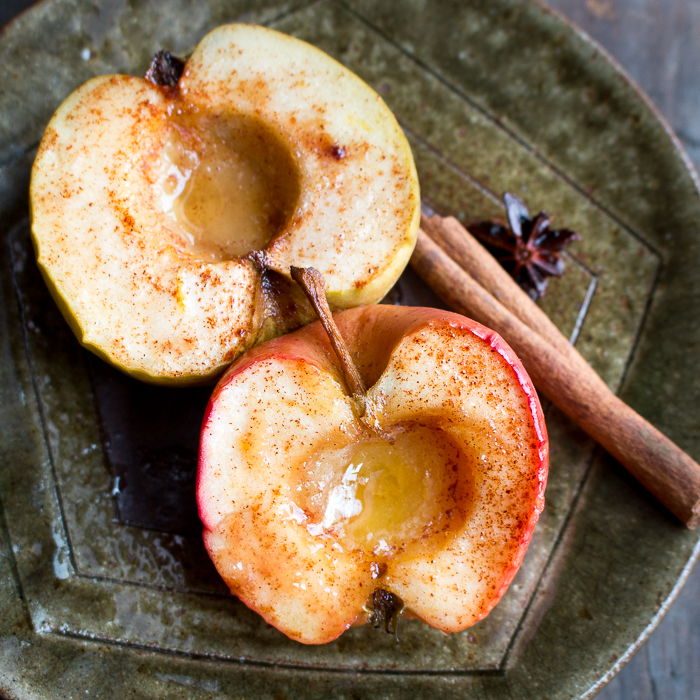 Cinnamon Baked Apples just 2 plain ones in a plate with whole cinnamon stick and anise seed