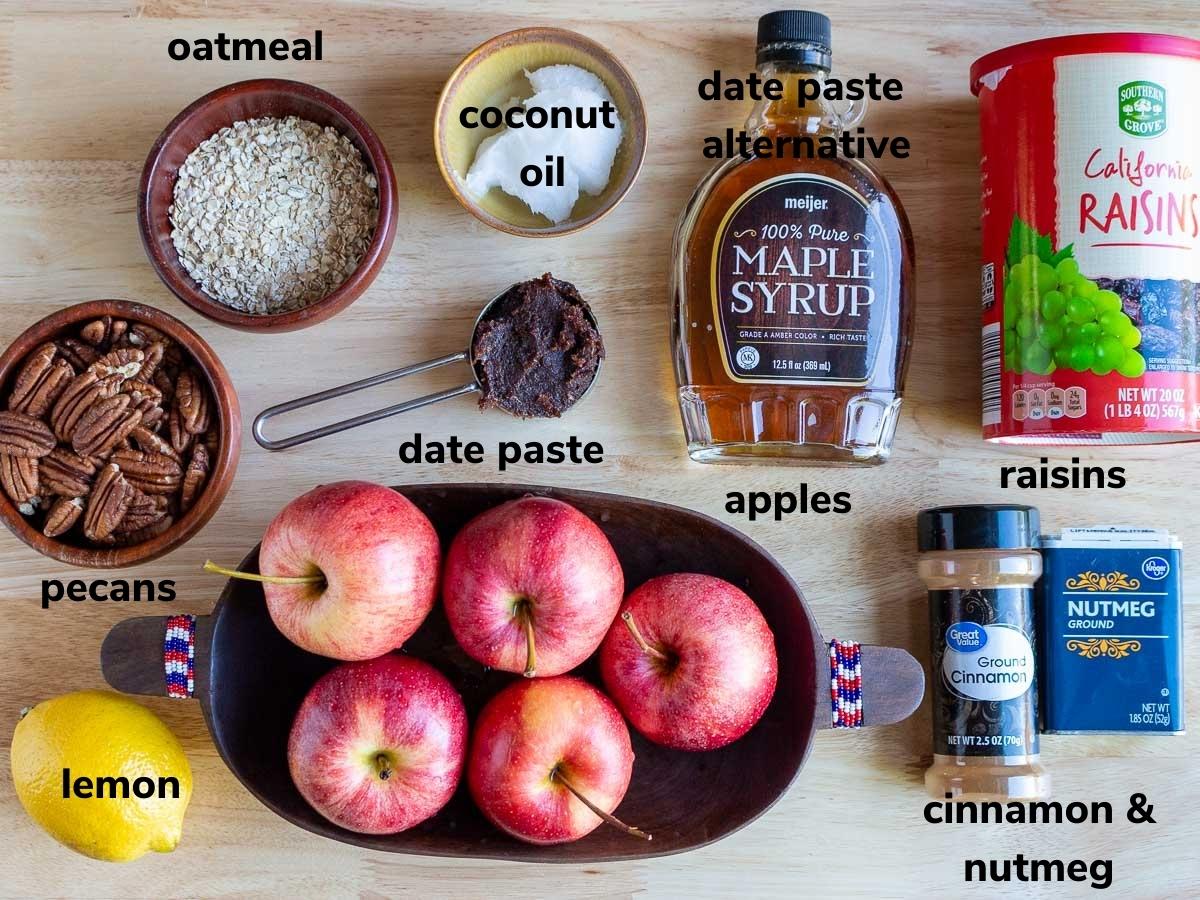 Ingredients to make air fryer apples laid out on a wooden board. 