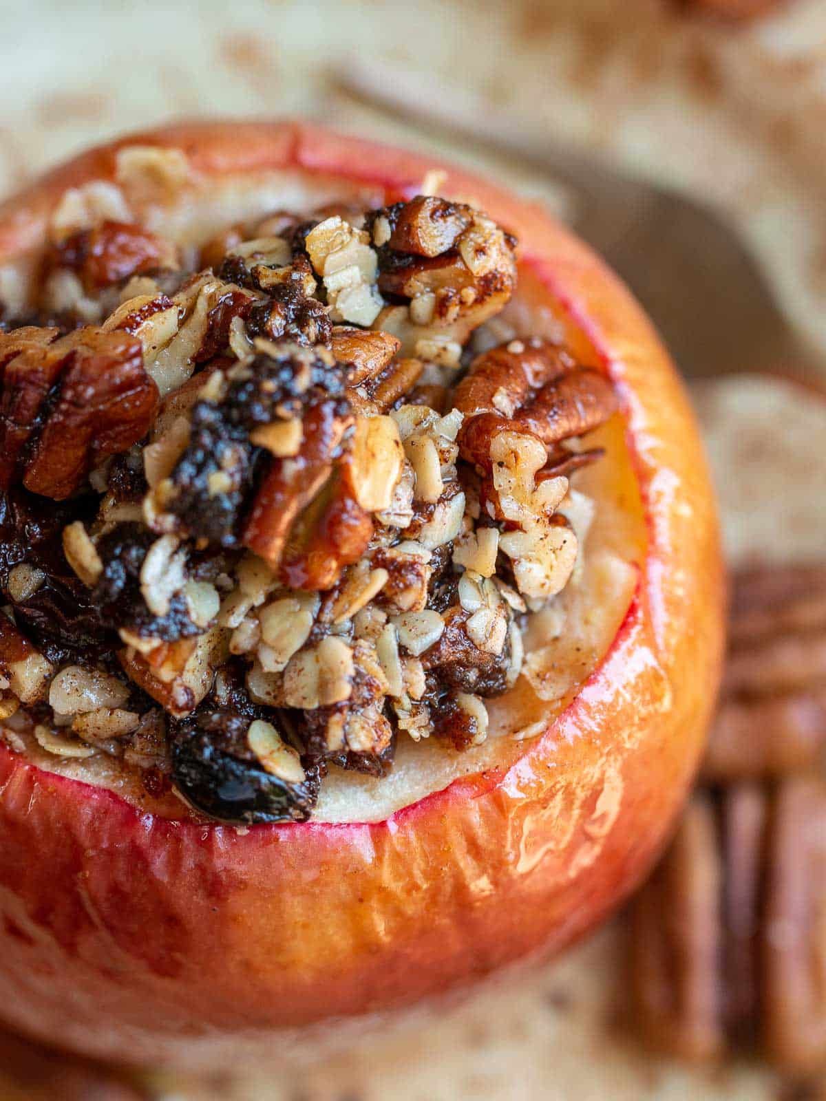 Close up shot of the filling of the stuffed baked apple showing the date paste, pecans and oats inside the apple.