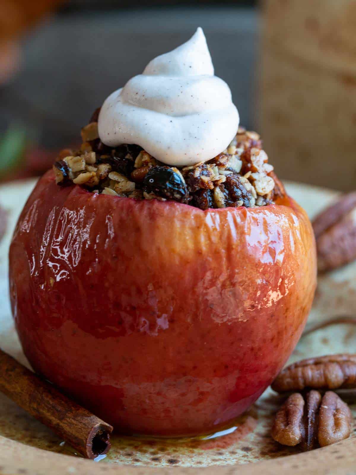 Air fried stuffed baked apple garnished with pecans and a dollop of whipped coconut topping.