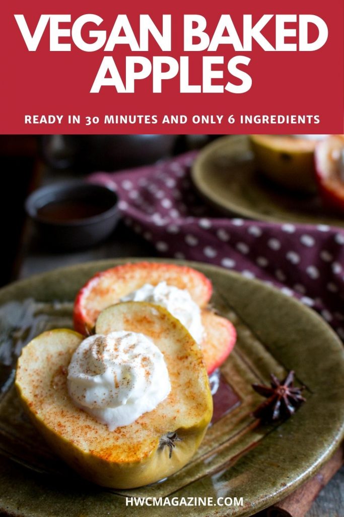 Baked half apples on a green plate topped with coconut whipped topping.
