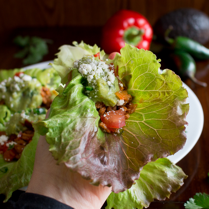 Holding the turkey taco lettuce wrap in our hand ready to take a bite