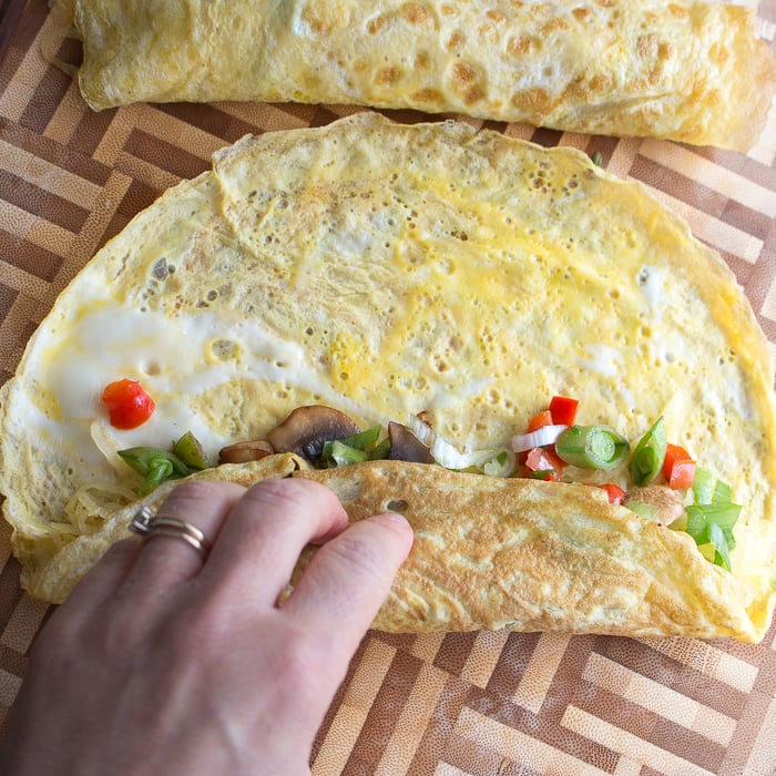 rolling up our skinny spaghetti squash egg roll ups like a burrito