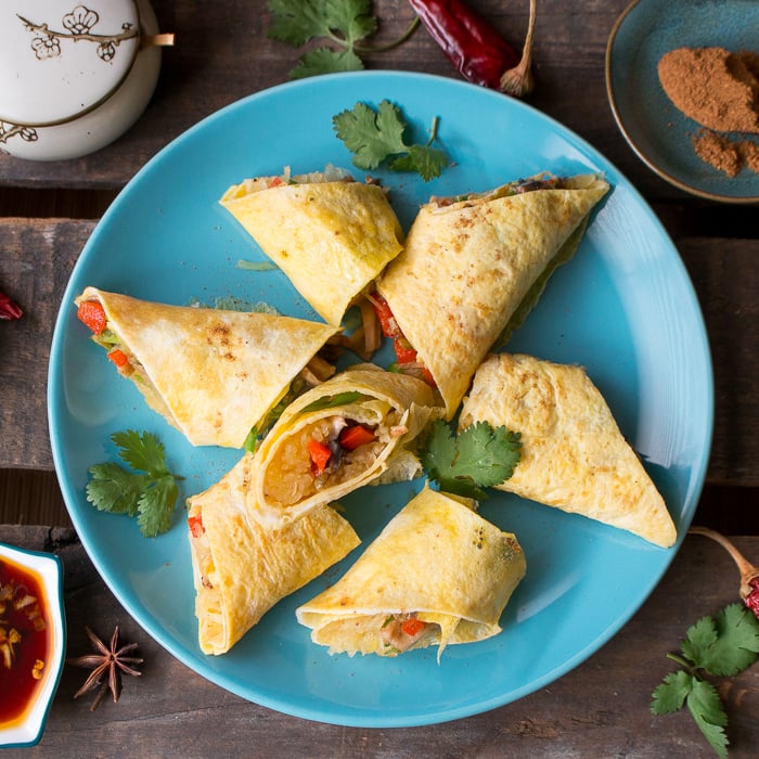 Top down photo of Skinny Spaghetti Squash Egg Roll Ups on blue plate