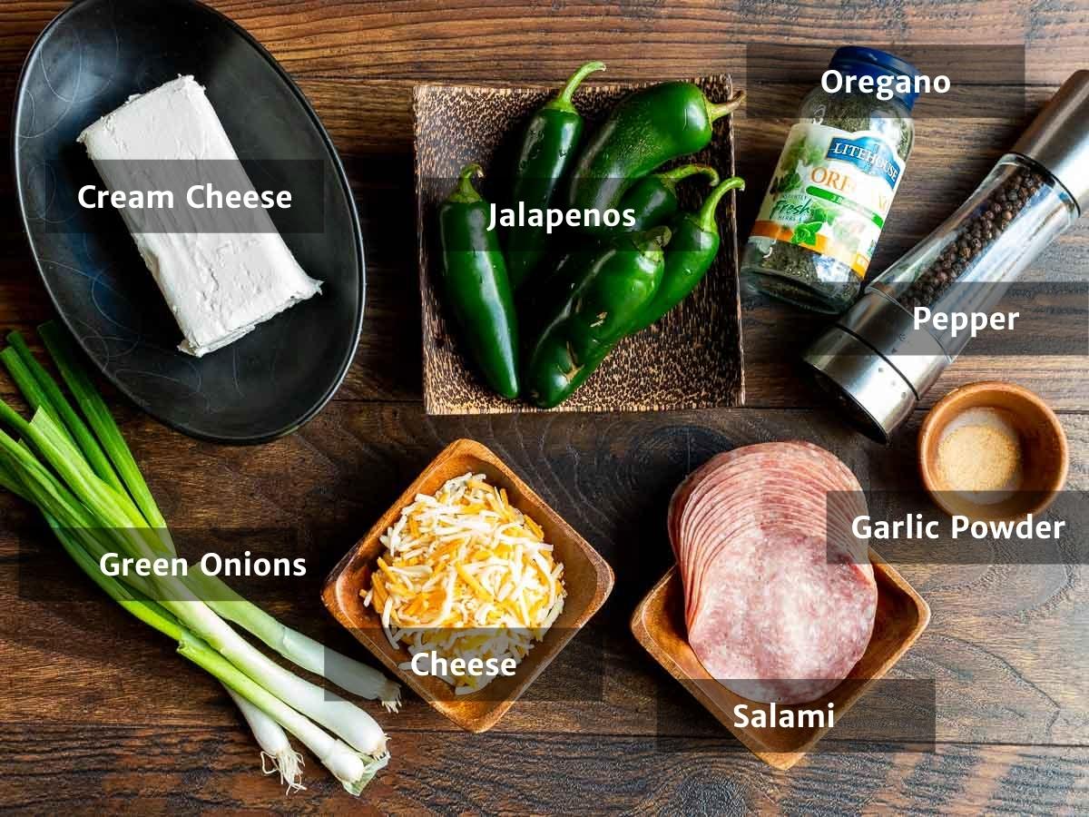 Ingredients to make cheesy keto jalapenos laid out on a wooden board.