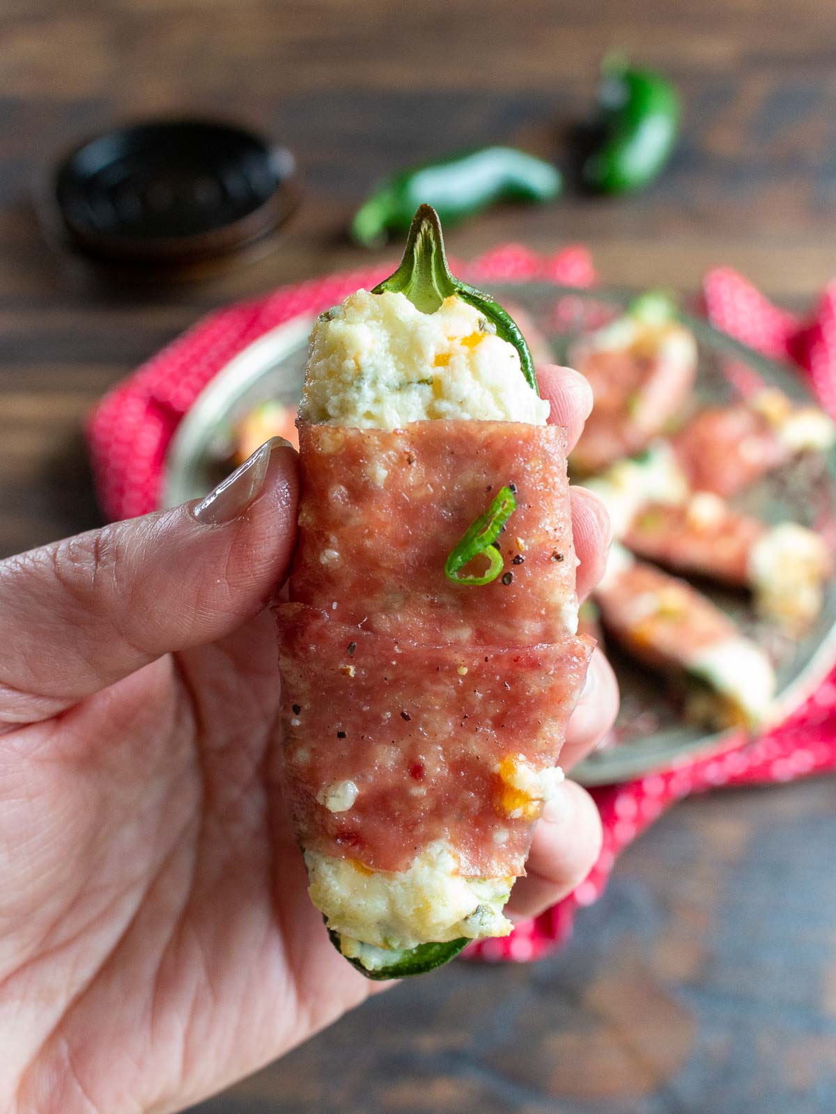 Holding an air fried jalapeno popper. 