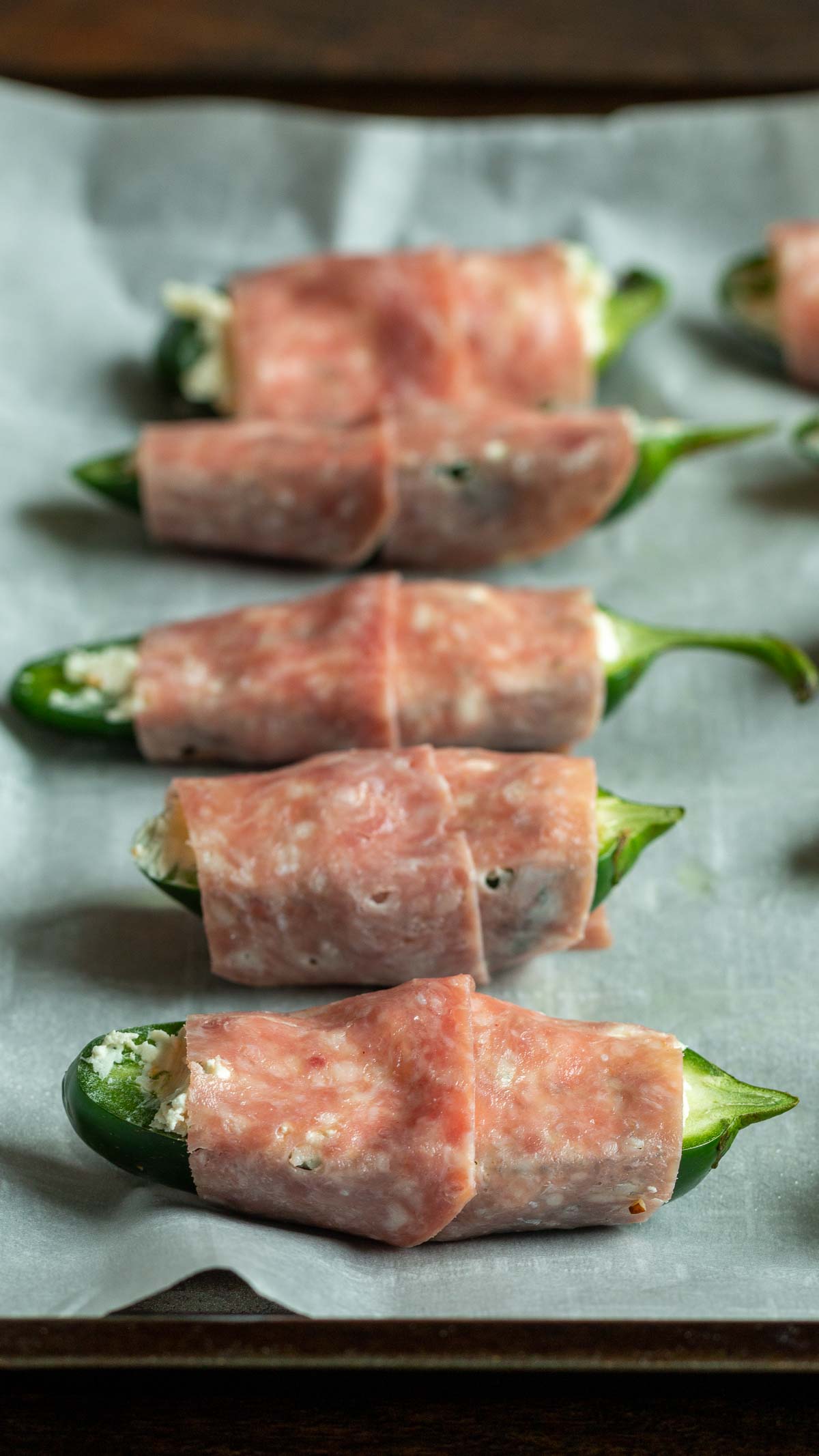 salami wrapped jalapeno poppers ready for the air fryer.