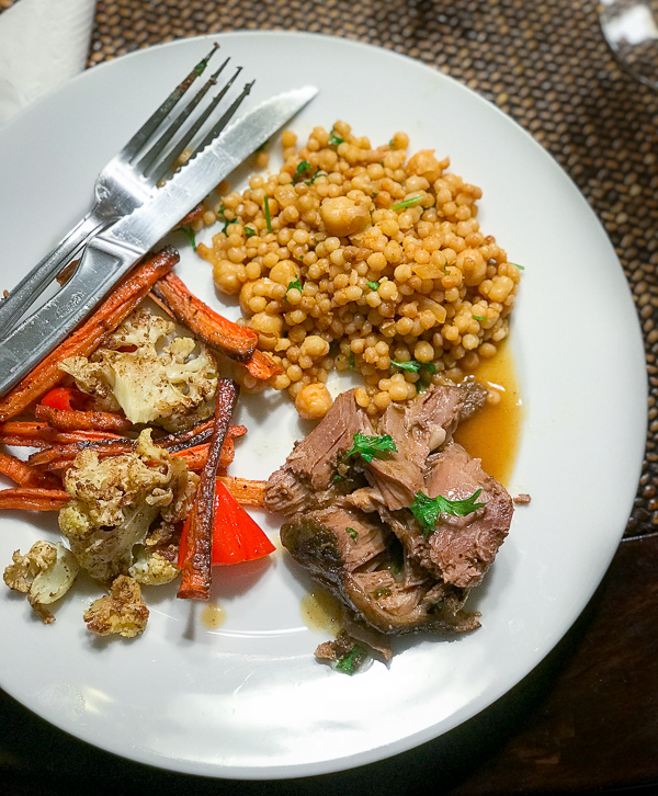 leg of lamb served with roasted veggies and Israeli Couscous