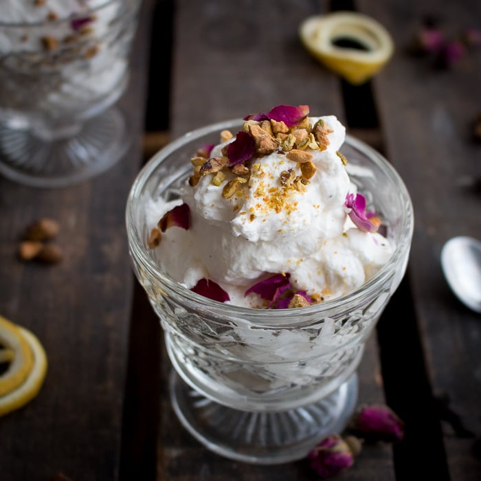 Mousse topped with rose petals and pistachio nuts.