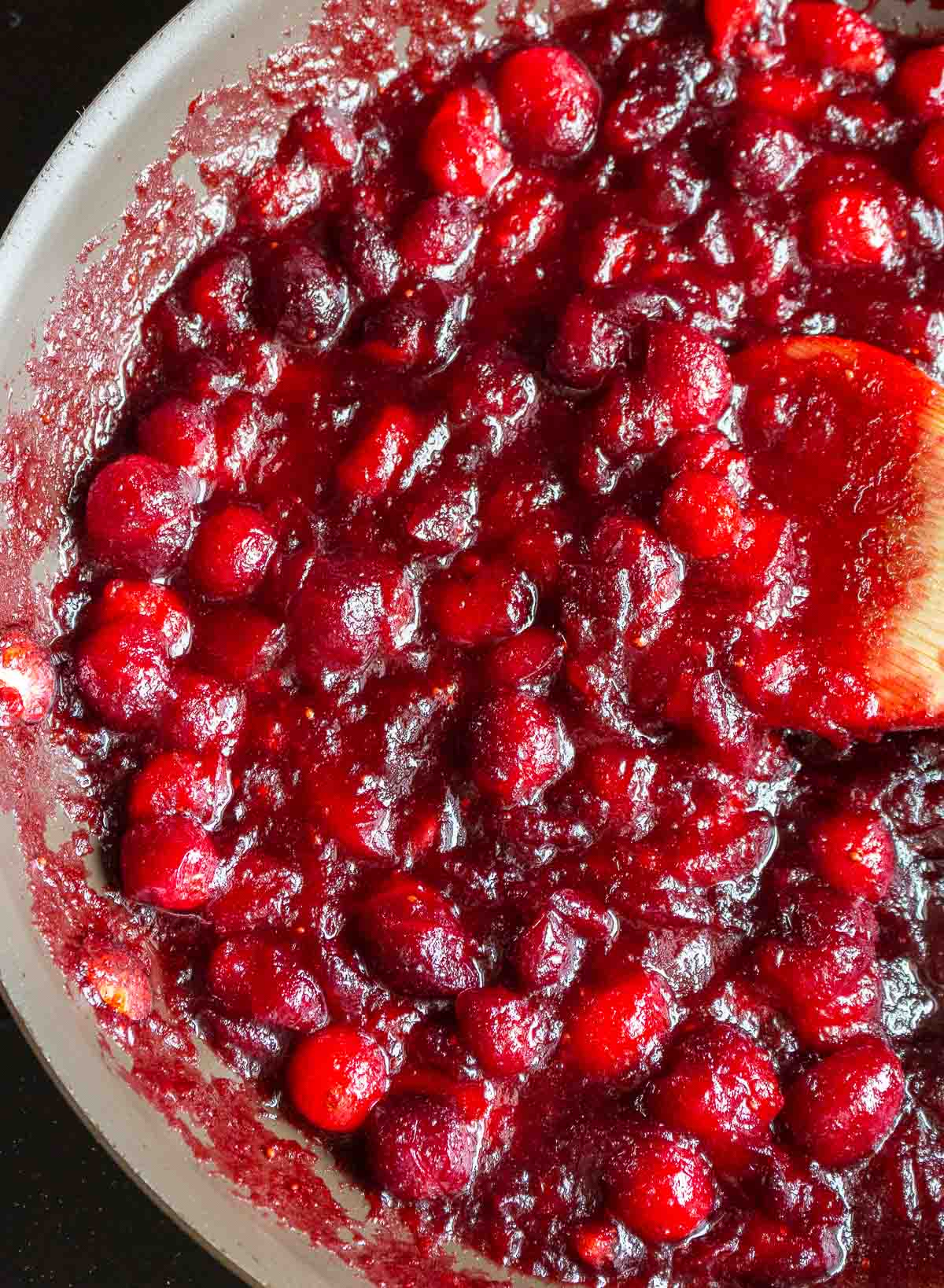 Cranberry sauce glaze cooking in a pan.