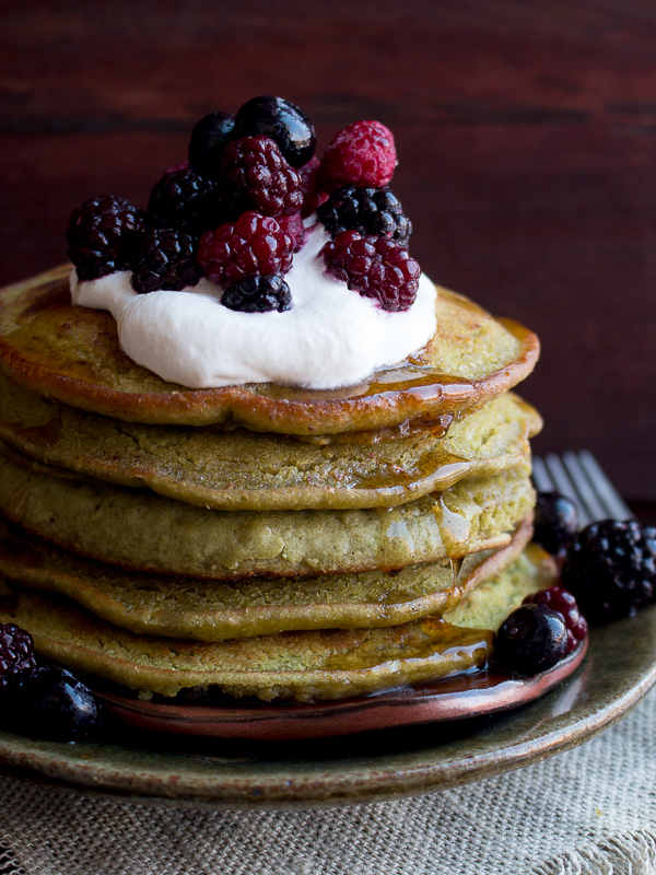 Seriously sexy pancakes topped with homemade coconut whipped cream and berries.
