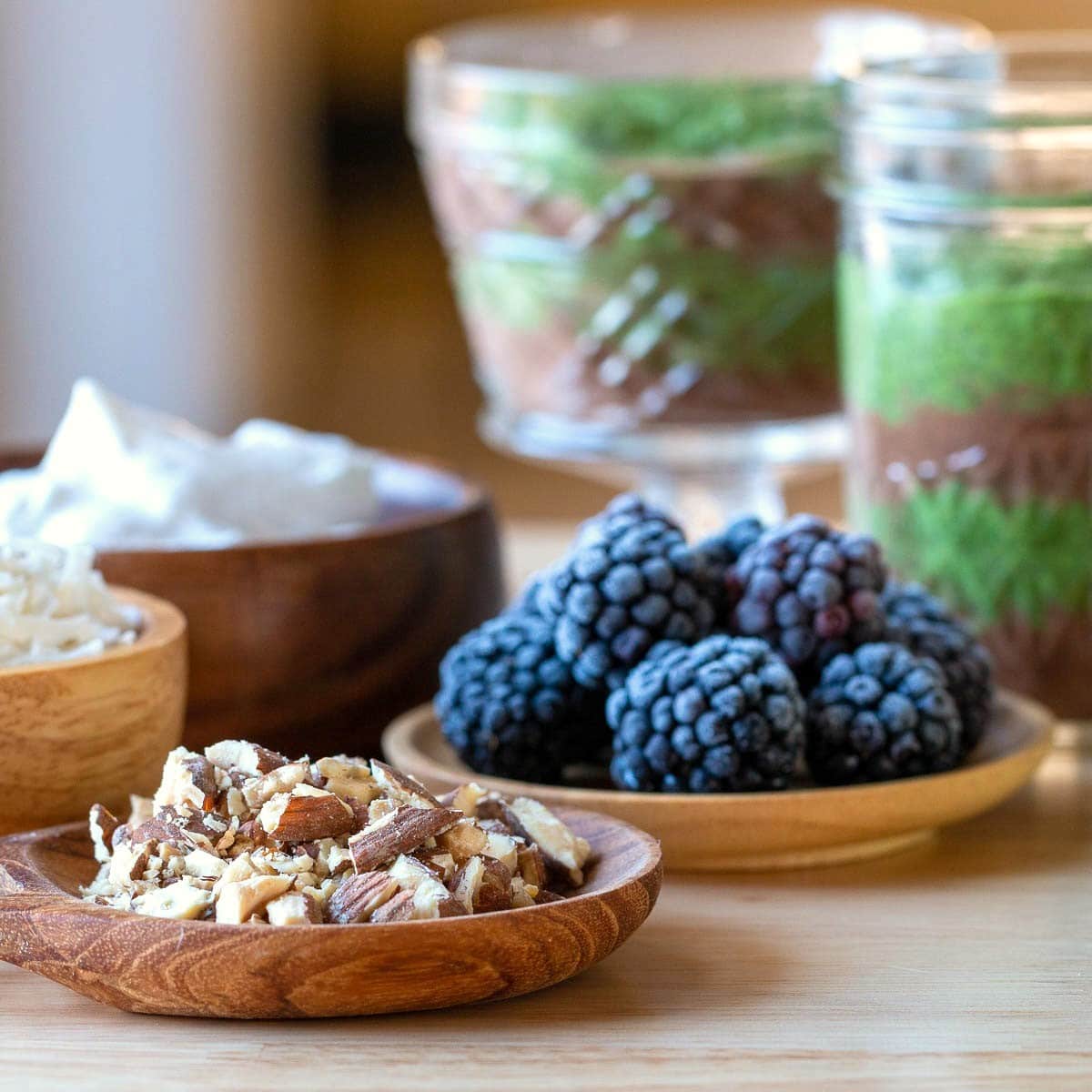 Nuts, berries and coconut cream toppings for chia seed pudding.