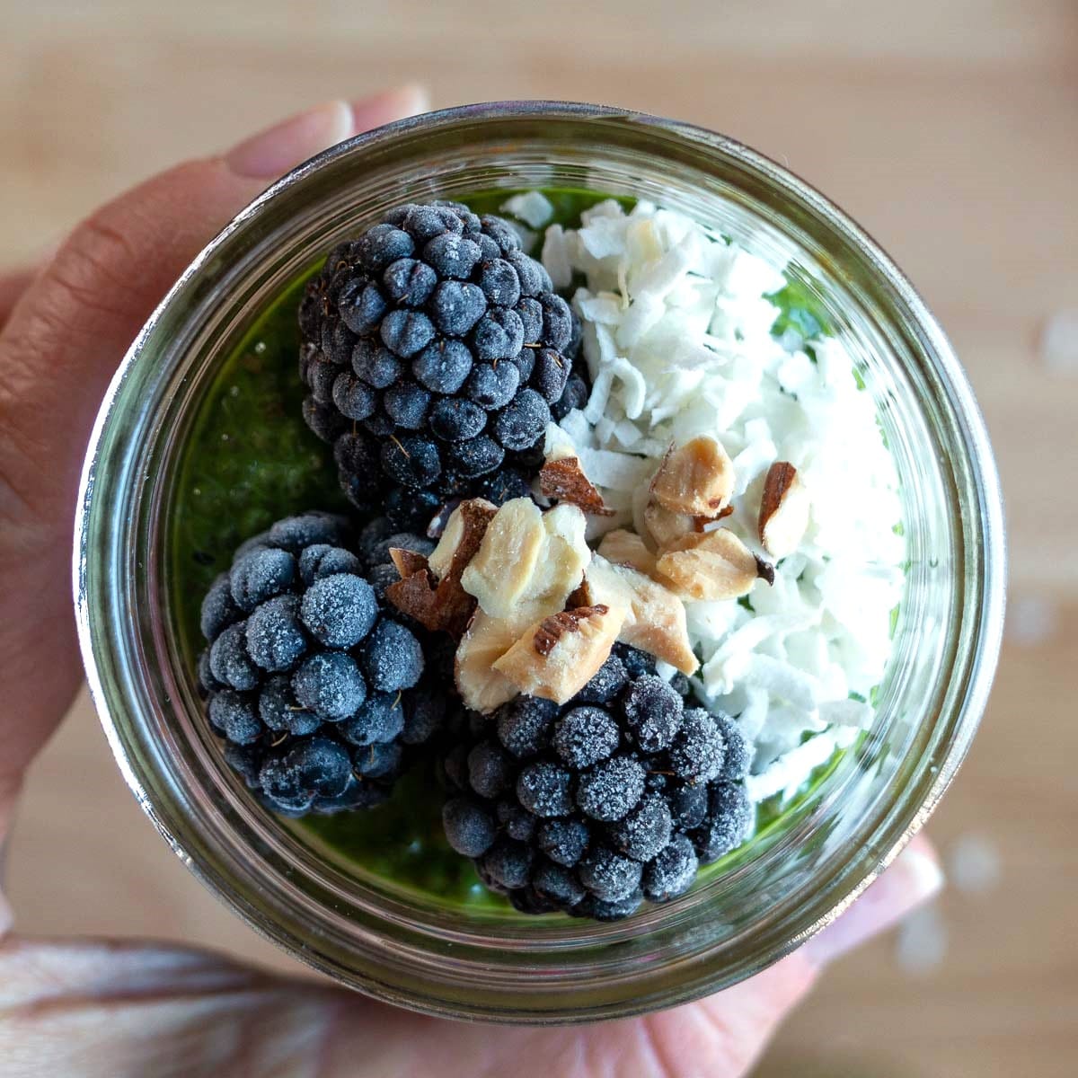 Top of the chocolate matcha recipe showing the blackberries, coconut and nuts. 