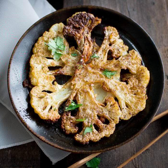 Crispy Roasted Cauliflower Bites on a black plate.