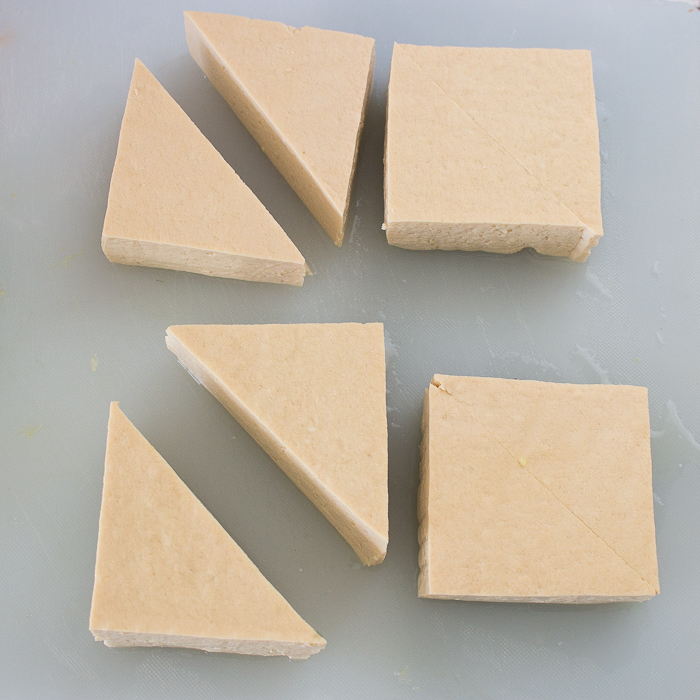 Firm Tofu cut into triangles.