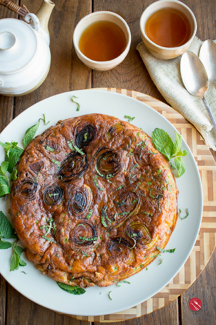 Stove Top Parmesan Leek Frittata just out of the oven with 2 glasses of tea and teapot.