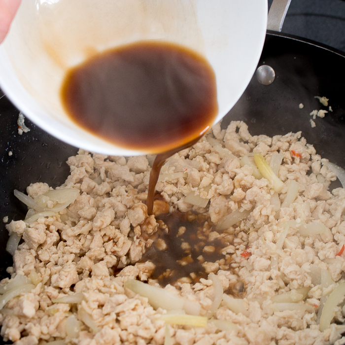 Special thai Sauce getting poured into the stir fried chicken.