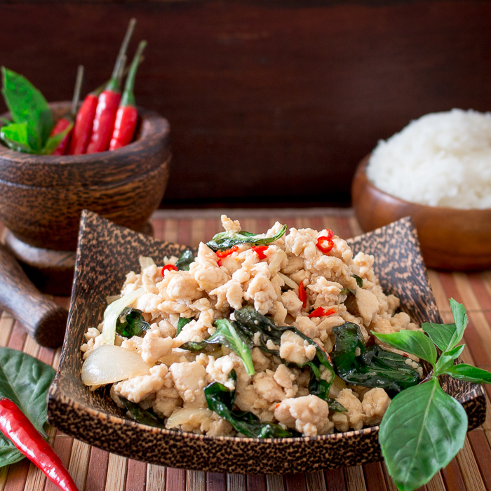 Spicy Holy Basil Chicken (Pad Krapow Gai) in a wooden bowl.