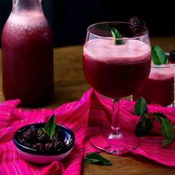 Blackberry Mint Agua Fresca with a deep purple color.