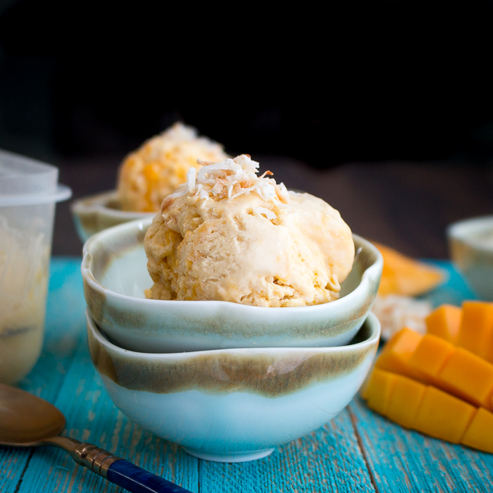 Single large scoop of the mango ice cream in a blue bowl.