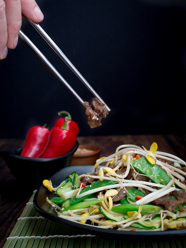 Grabbing a piece of beef with Korean silver chopsticks.