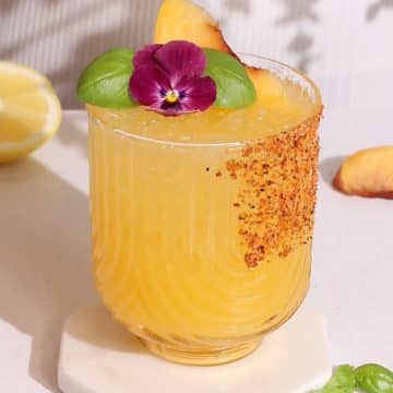 peach mocktail garnished with fruit.