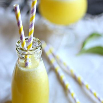 Pinapple lemonade in tall glass with straws.