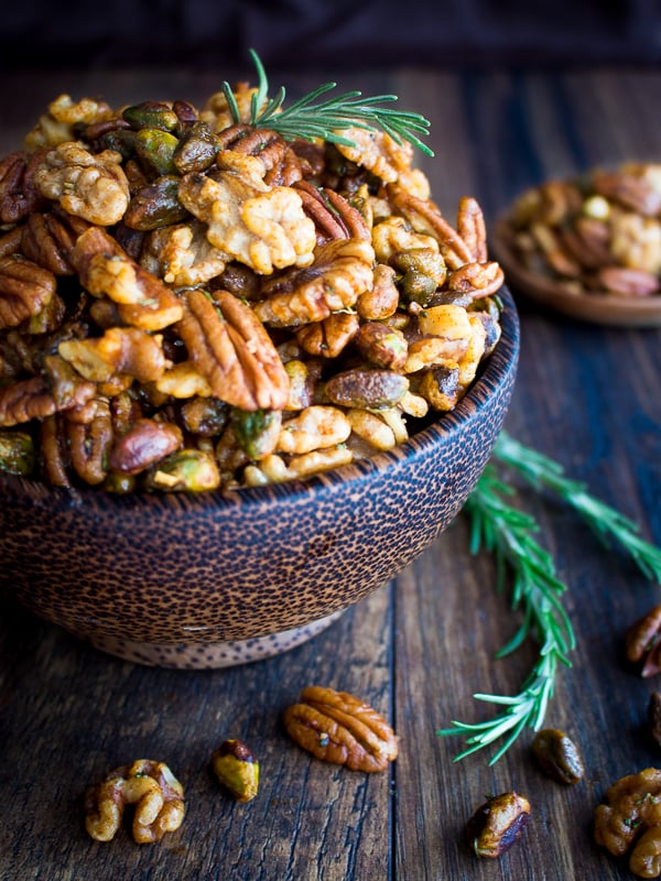 Party Nuts with fresh rosemary in little wooden serving bowls.