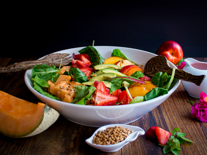 Super fresh and bright summer fruit salad with mixed greens and seasonal fruits.
