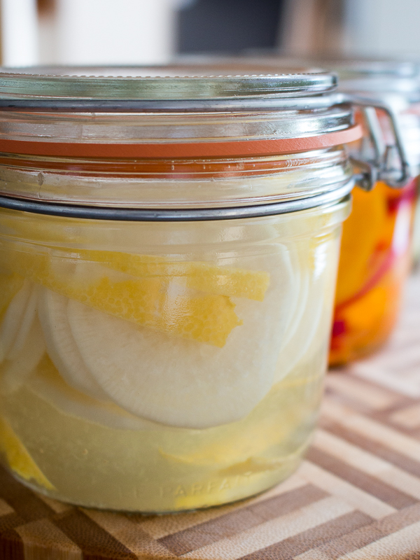 Daikon and lemon in a pickle jar.