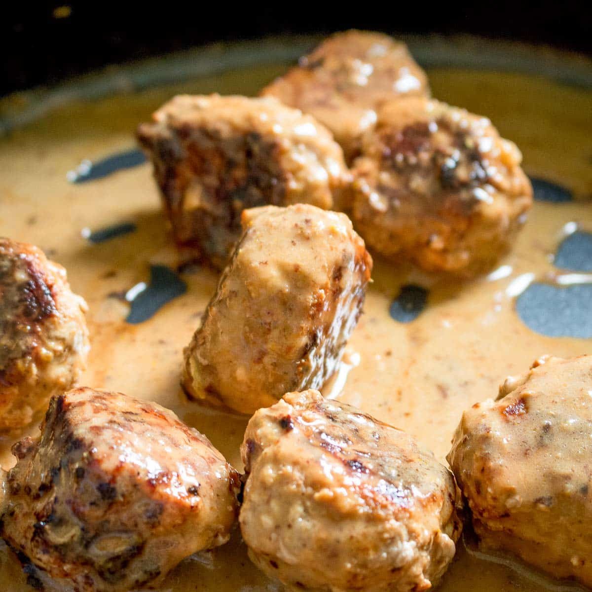 Tossing the meatballs in the curry sauce. 