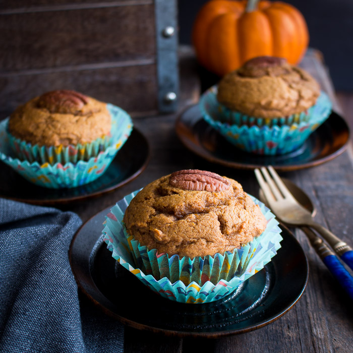 3 muffins on a black plates.