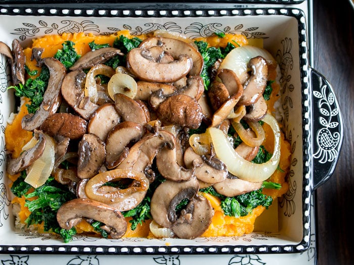 Mushrooms, onions and spinach on top of butternut squash puree.