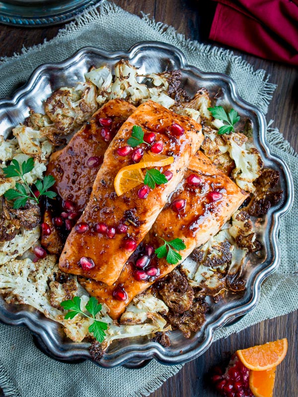 Baked Salmon served on a wooden table with holiday napkins. 