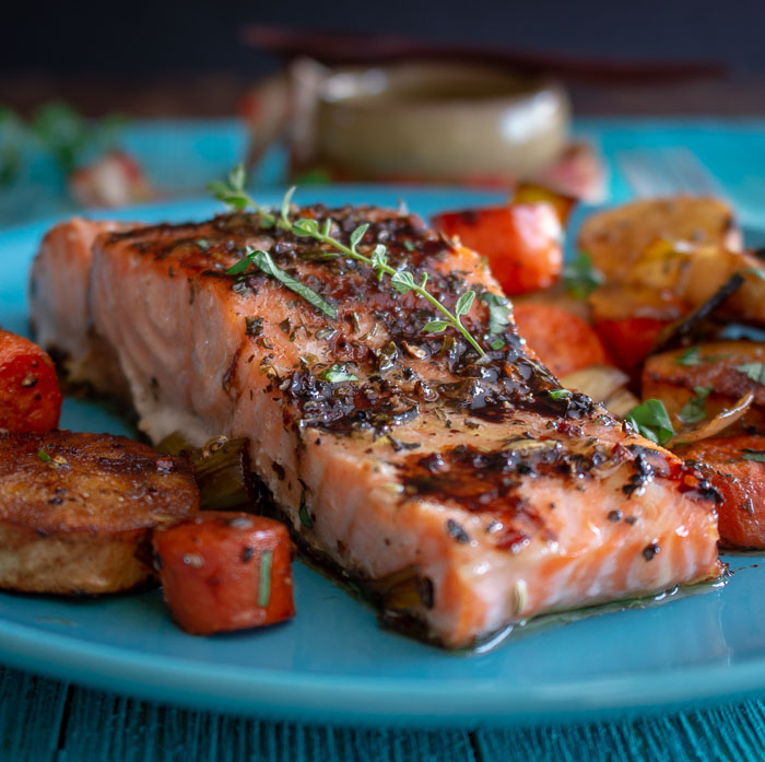 Balsamic Glazed Salmon and Roasted Root Vegetables  on a blue plate