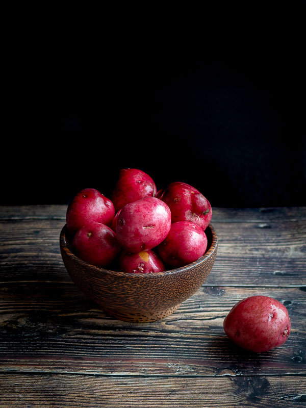 Red potatoes in a wooden bowl.