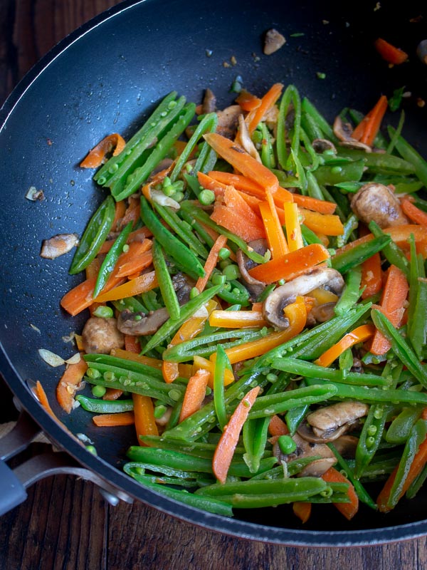 Vegetables stir frying in a wok.