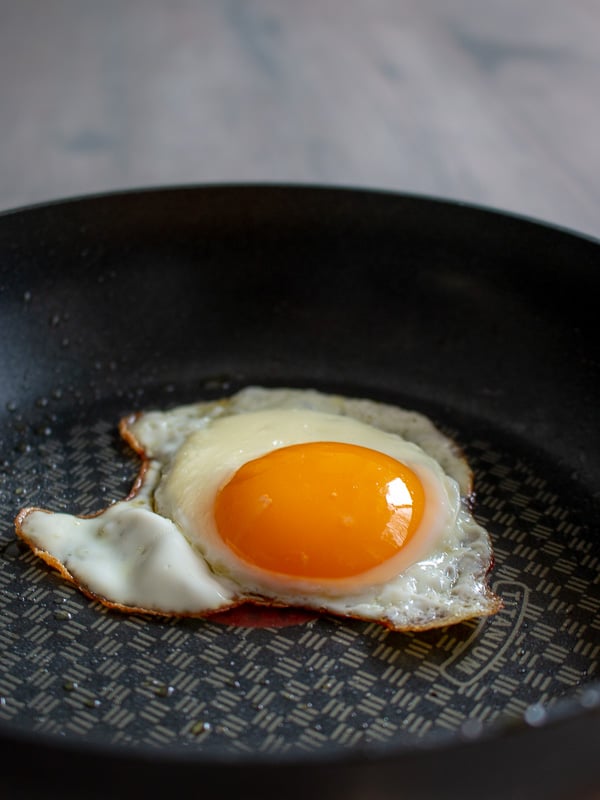 Perfectly cooked sunny side up egg in a frying pan.