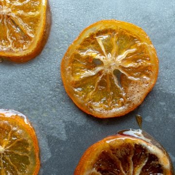 Honey Candied Meyer Lemon Slices on a baking sheet drying.