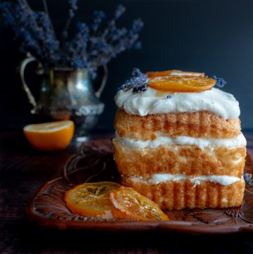 Icebox Lavender Lemon Angel Food Cake topped with beautiful honey candied meyer lemons and fresh lavender in the background.