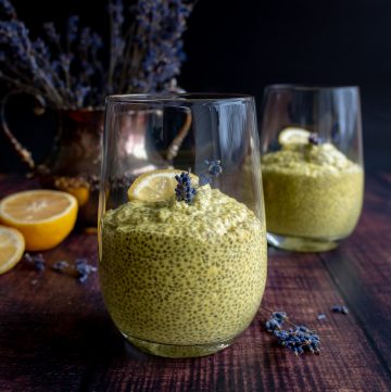 2 glasses with Lemony Lavender Chia Seed Pudding garnished with sprigs of lavender and lemon.