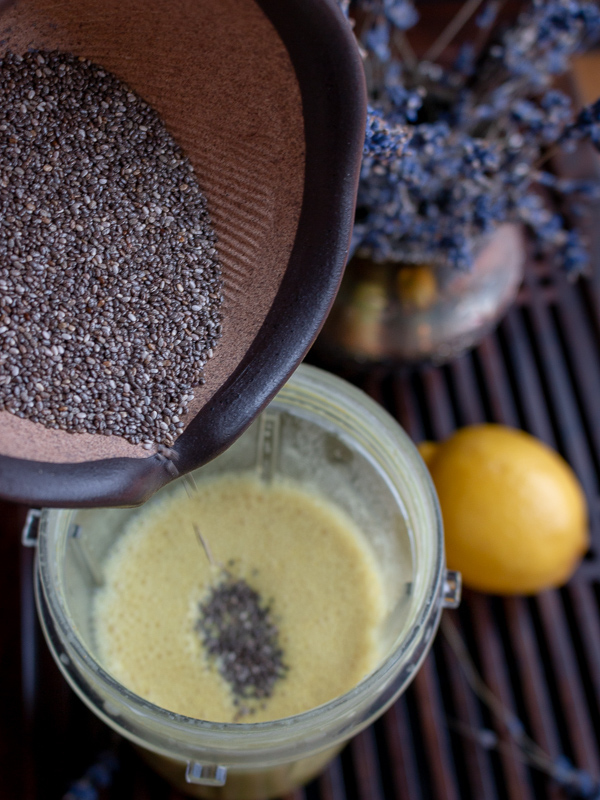 Adding black chia seeds to the almond milk.