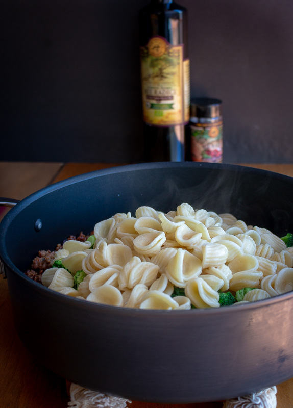 Steamy pasta added to the skillet. 