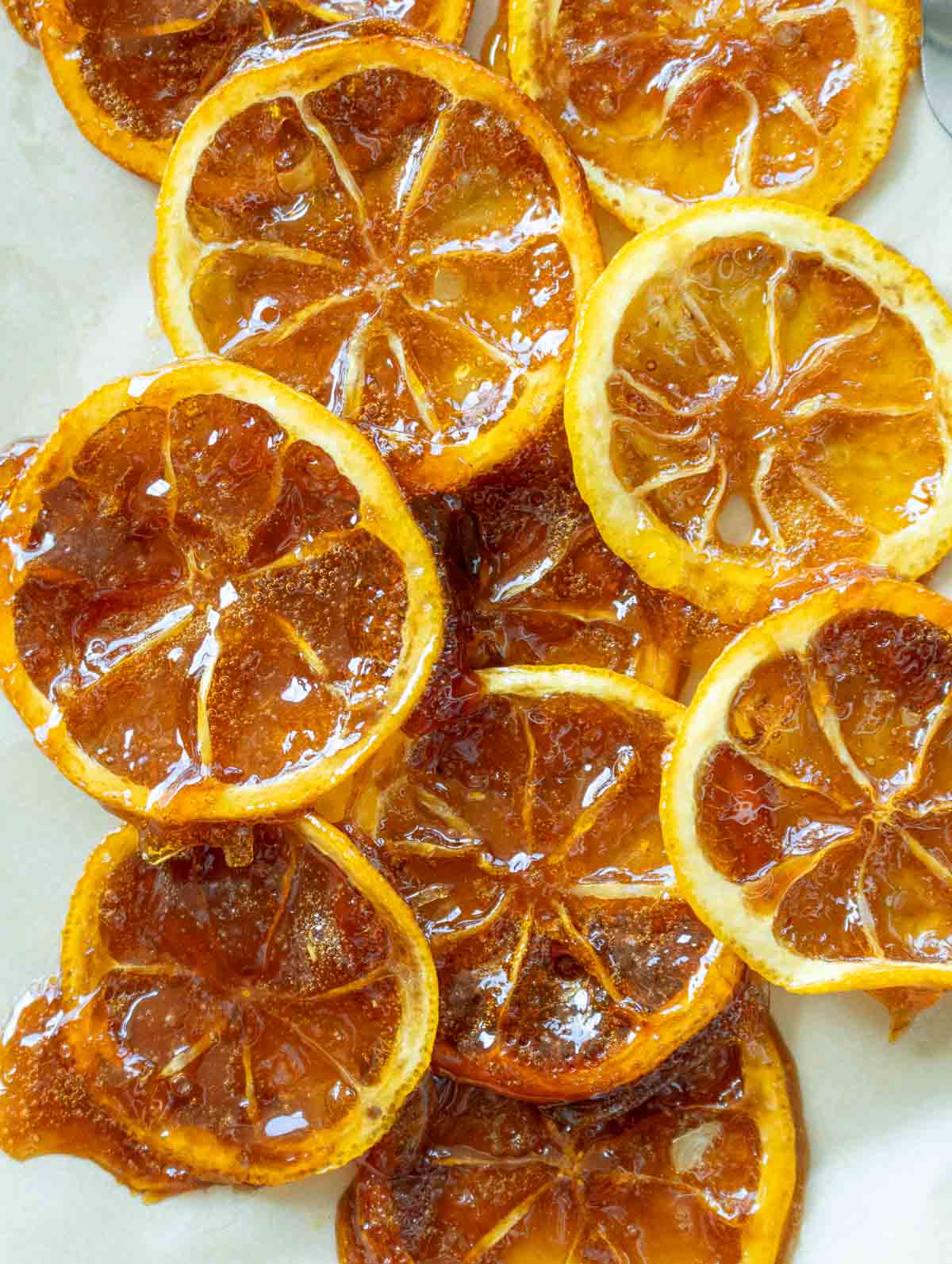 Collage of candied Meyer lemons drying.