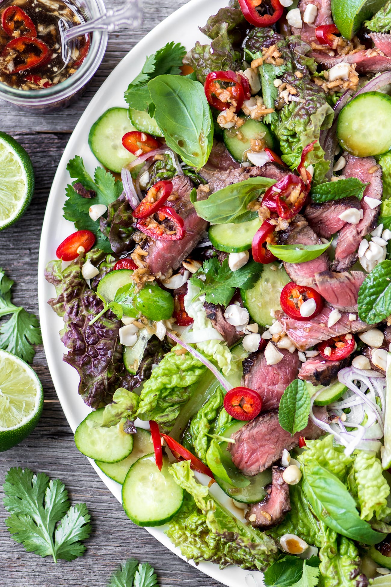 Thai Beef Salad garnished with chilis and limes