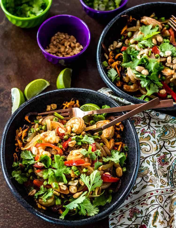 Thai Sweet Potato Bowls with shrimp and peas, garnished with limes and cilantro