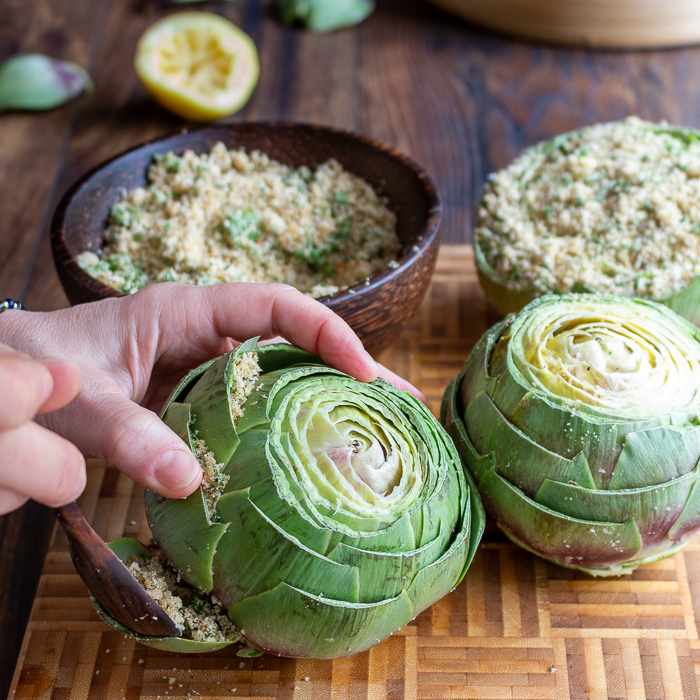 Artichokes gatting stuffing placed inside the leaves.