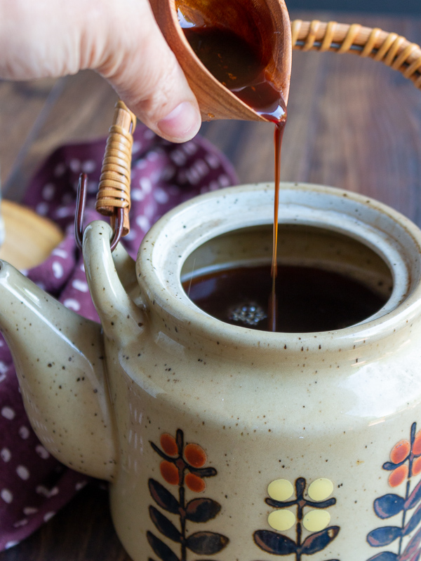 Thinned out date paste being poured into brewed Masala chai Tea. 