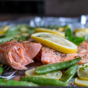 The bite shot! Flaky trout fish on a fork with a drizzle of lemon.